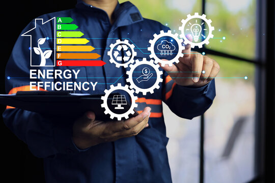 Engineer pointing to light bulb with energy efficiency labeling, which the residential home energy efficiency rating and customers decision to buy as value. Green building label CO2 emission reduce