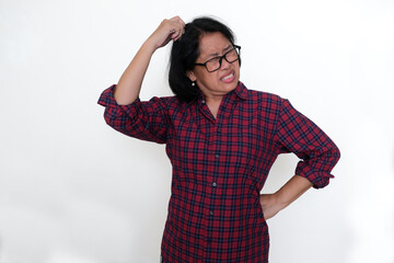 A middle-aged woman scratched her head in annoyance
