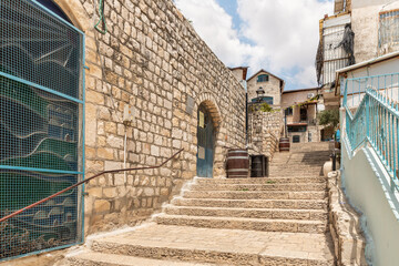A stone staircase leading up connects two quiet streets with stone houses in the old part of Safed...