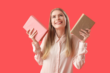 Young woman with books on red background