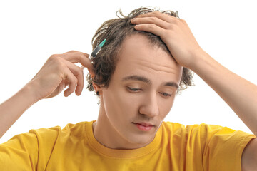 Young man with injection for hair growth on white background, closeup