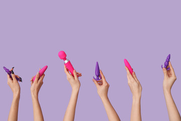 Women with vibrator and anal plugs on lilac background