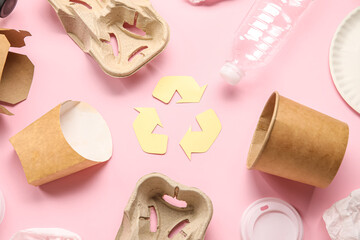 Recycling sign with garbage on pink background