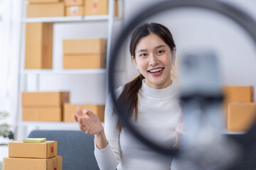 Portrait of Starting small businesses owners female entrepreneurs working on receipt box and check online orders to prepare to pack the boxes, sell to customers, sme business ideas online.
