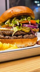 hamburger burger with ban french fries on table bacon egg onion