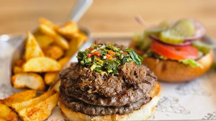 hamburger burger with ban french fries on table bacon egg onion