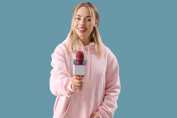 Female journalist with microphone on blue background