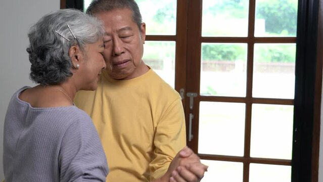 Romantic senior family couple wife and husband dancing to music together in living room , spending time together. Active seniors Retirement Hobby And Leisure.