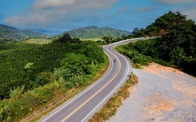 The highway stairs to the sky of road trough with green nature forest  as the natural landscape...