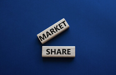 Market Share symbol. Wooden blocks with words Market Sharer. Beautiful deep blue background. Business and Market Share concept. Copy space.