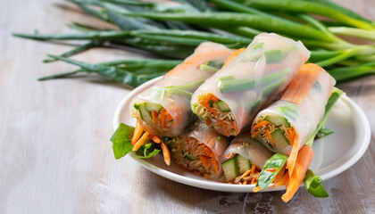 Vegan spring rolls with carrots, cucumber, green onions and rice noodles, selective focus - obrazy, fototapety, plakaty