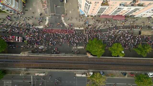 Nice aerial top view flight 
CSD Pride Love Parade 2023 in city Berlin Germany Summer day. vertical bird's eye view drone
4K Cinematic footage.