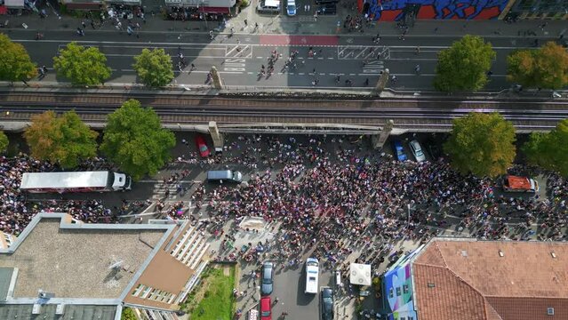 Gorgeous aerial top view flight 
CSD Pride Love Parade 2023 in city Berlin Germany Summer day. vertical bird's eye view drone
4K Cinematic footage.