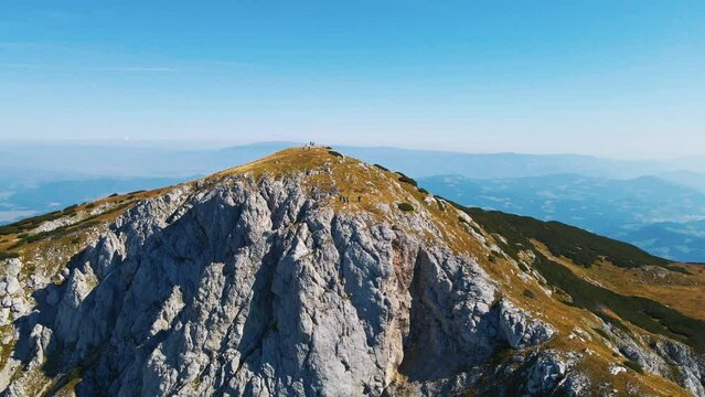 Stunning 4K drone footage of Saddle bellow Kordezeva Glava - Peca mountain in Karavanke mountain range. Beautiful Slovenian scenery of peaks of Kamnik-Savinja Alps in the background. Summer time.
