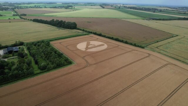 High angle view approaching cut throat razor crop circle pattern aerial view in Hackpen hill, Swindon, 2023