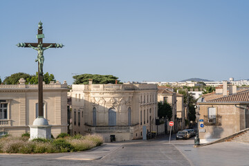 Cityscape view of landmark bronze calvary and ancient stone buildings on place Giral, Montpellier,...