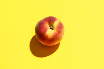 Sweet peach on yellow background