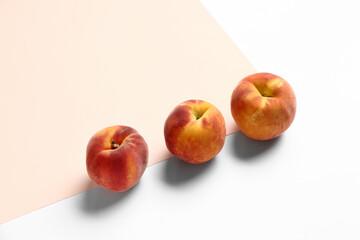 Sweet peaches on colorful background