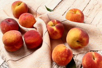 Fototapeta na wymiar Many sweet peaches on white wooden background