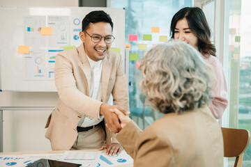 Obraz premium Two confident business man shaking hands during a meeting in the office, success, dealing, greeting and partner