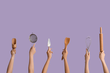 Female hands with baking utensils on lilac background