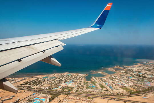 Aerial View of the Red Sea Coast in Hurghada, Egypt with many hotels bay out of airplane landing