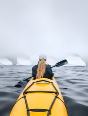 Naklejka premium Rear view of woman kayaking at Antarctica