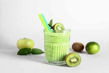 Glass of fresh kiwi smoothie with mint on white background