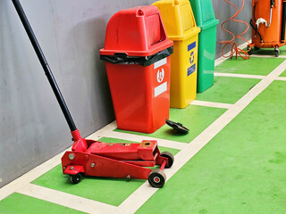 Trash cans for garbage separation and Floor Jack Lift Vehicle Servicing and Maintenance Inside Auto...