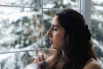 Girl posing near a large beautiful window