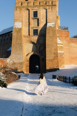 Girl in a white dress on a photo of the castle