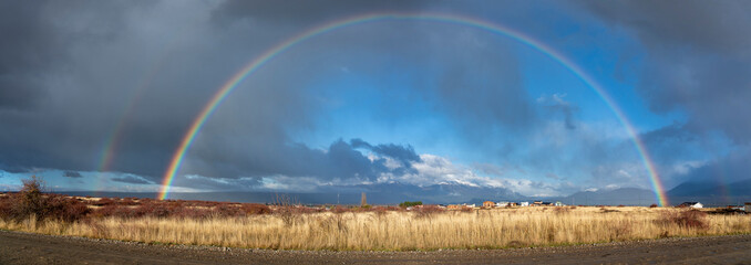 Panoramic view of a double rainbow over Trevelin town in Patagonia