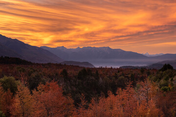 orange sky sunset with Autum colored trees in Patagonia