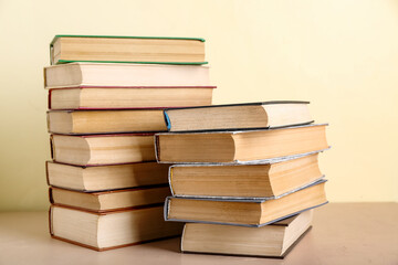 Stacks of books on beige table