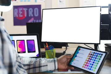 Midsection of indian male designer using tablet and computer with copy space at desk in office