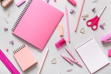 Different school stationery and notebooks on grey background