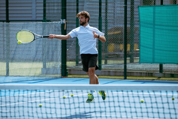 Tennis player training on a professional tennis court.