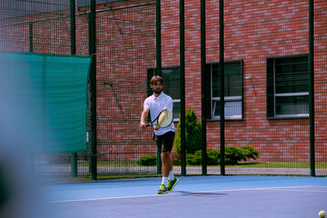 Tennis player training on a professional tennis court.