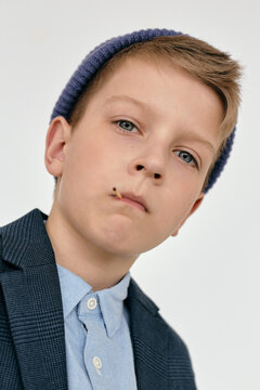 Low angle portrait of confident boy wearing stylish outfit looking at camera
