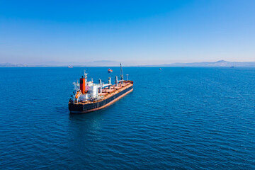 Bulk carrier ship anchored in Aegean sea waiting entering port, Aerial view