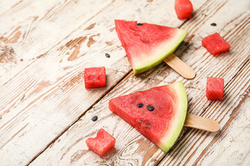Composition with tasty watermelon sticks on light wooden background, closeup
