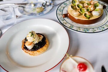 A spread of French dishes at a bistro in Circular Quay, Sydney: escargot in garlic parsley butter;...