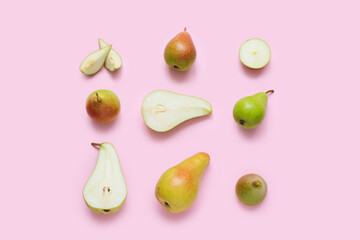 Different types of ripe pears on pink background