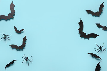 Paper bats and spiders for Halloween party on blue background