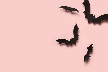 Paper bats for Halloween party on pink background