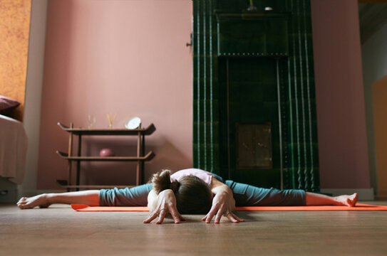 Eye-level shot of a woman doing wide-angled seated forward bend