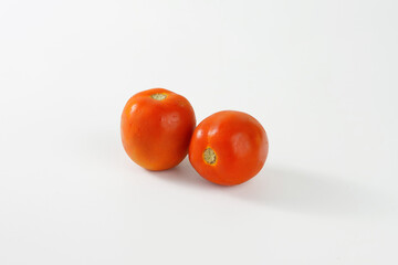 Photo of closeup of a red tomato isolated on a white studio background