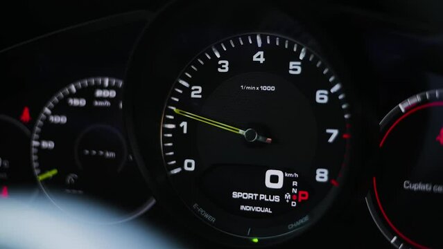 Close up shot of the RPM gauge, revving a luxury sport car