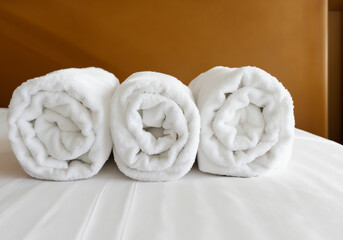 Obraz na płótnie Canvas Clean bath towels on bed in hotel suite MADE OF AI