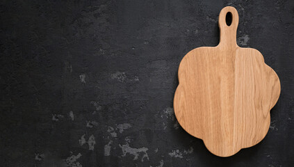 Wooden cutting board on dark background, banner. Concept of preparing food